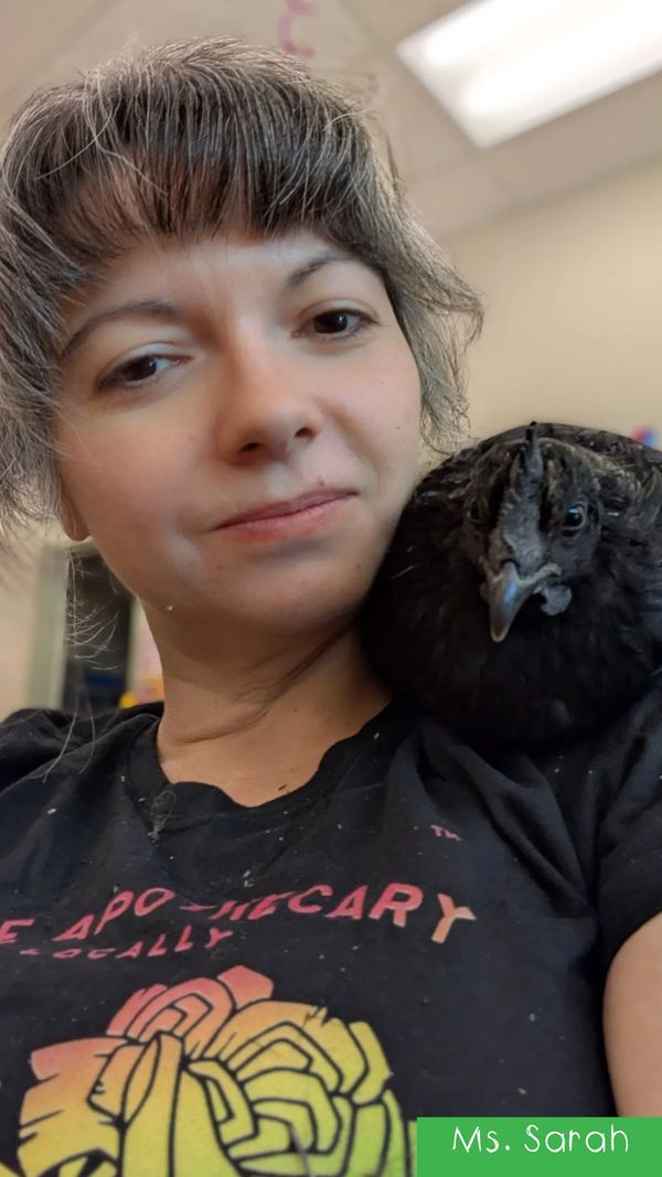 Woman with a black bird on her shoulder.