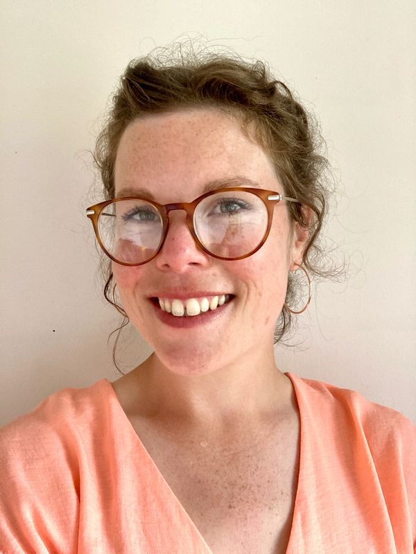 picture of Annie the crochet teacher wearing glasses with hair tied back wearing a pink blouse