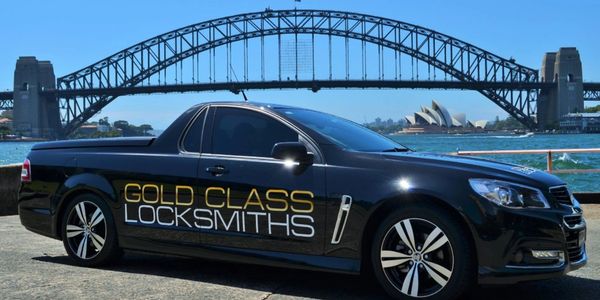 Car with gold Class Locksmith Logo on it for delivery services 