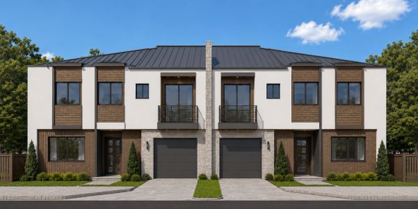 Modern duplex house with garages and balconies.