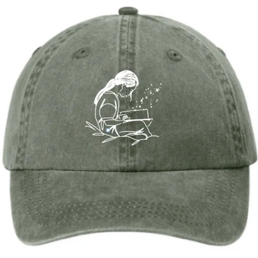 Green cap with a white line drawing of a girl reading and sparkles.