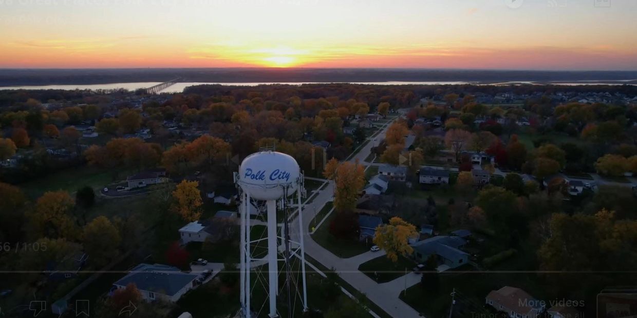 Sunset over Polk City with a water tower in view.