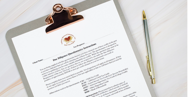 A clipboard holds a printed questionnaire with a pen beside it on a wooden surface.