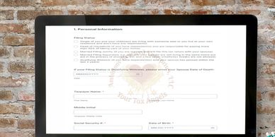 A computer screen displays a detailed personal information form against a brick wall.