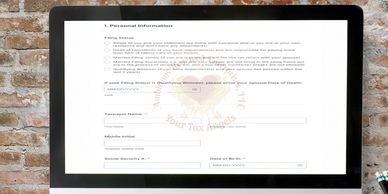 A computer screen displays a detailed personal information form against a brick wall.