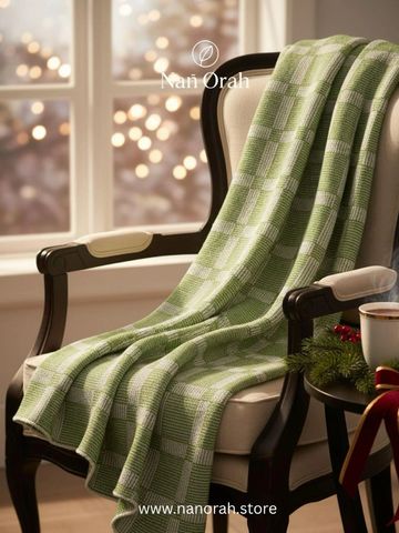 Green patterned blanket draped over an elegant chair by a festive table.