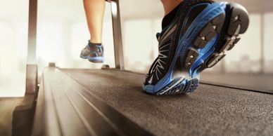 A close up of a person running on a treadmill