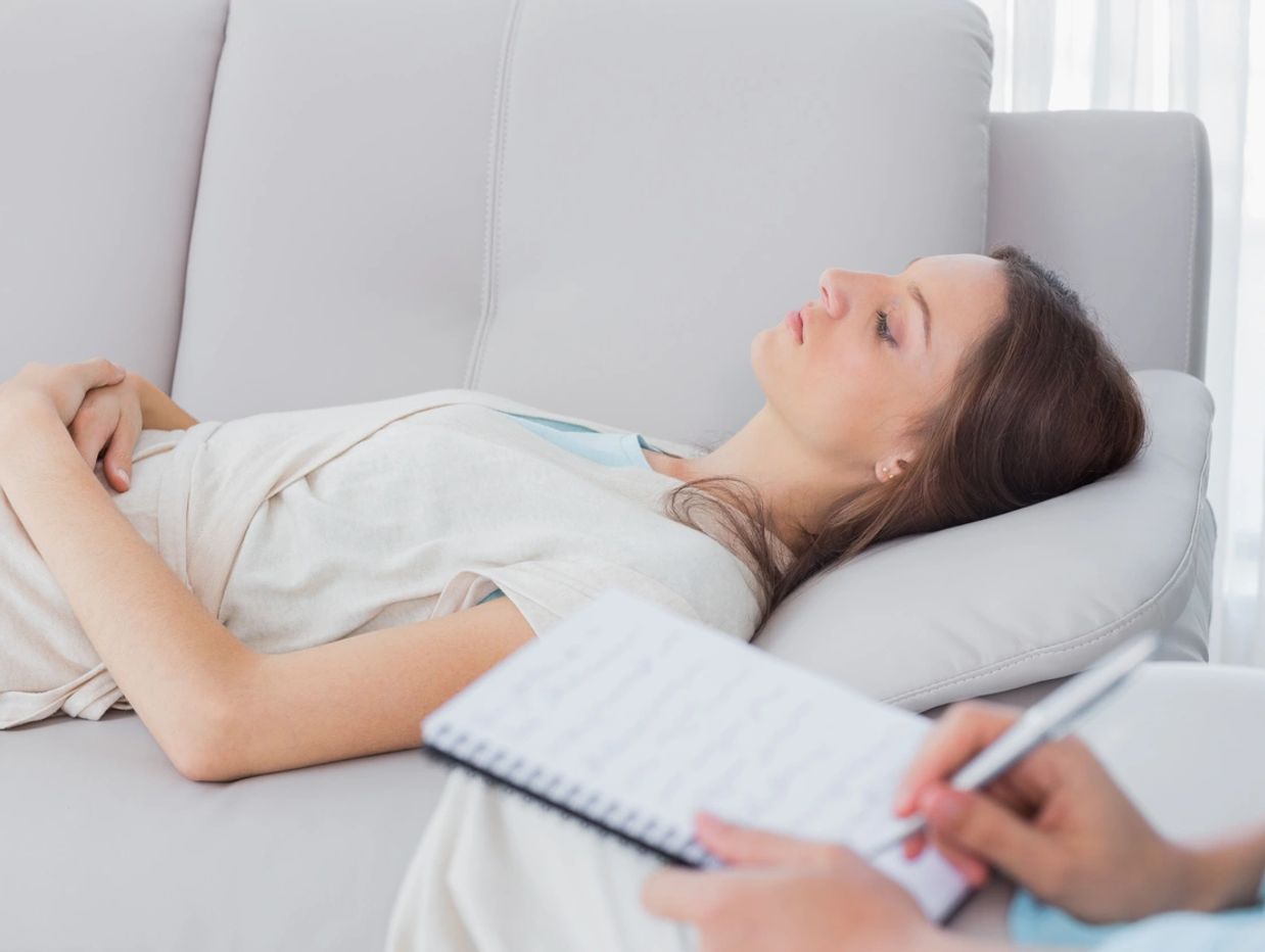 Woman lying on a couch during a therapy session.