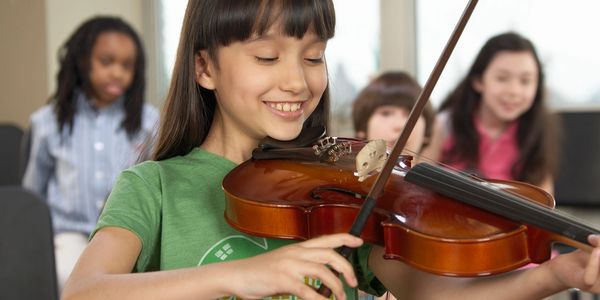 Closeup shot of a girl playing a violin