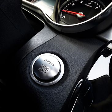 Focused image of a start engine button on the inside of a car