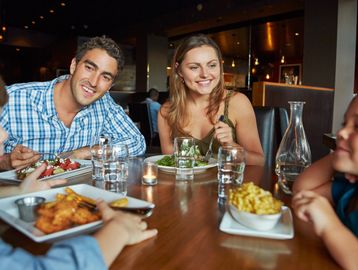 people sitting a table eating a meal