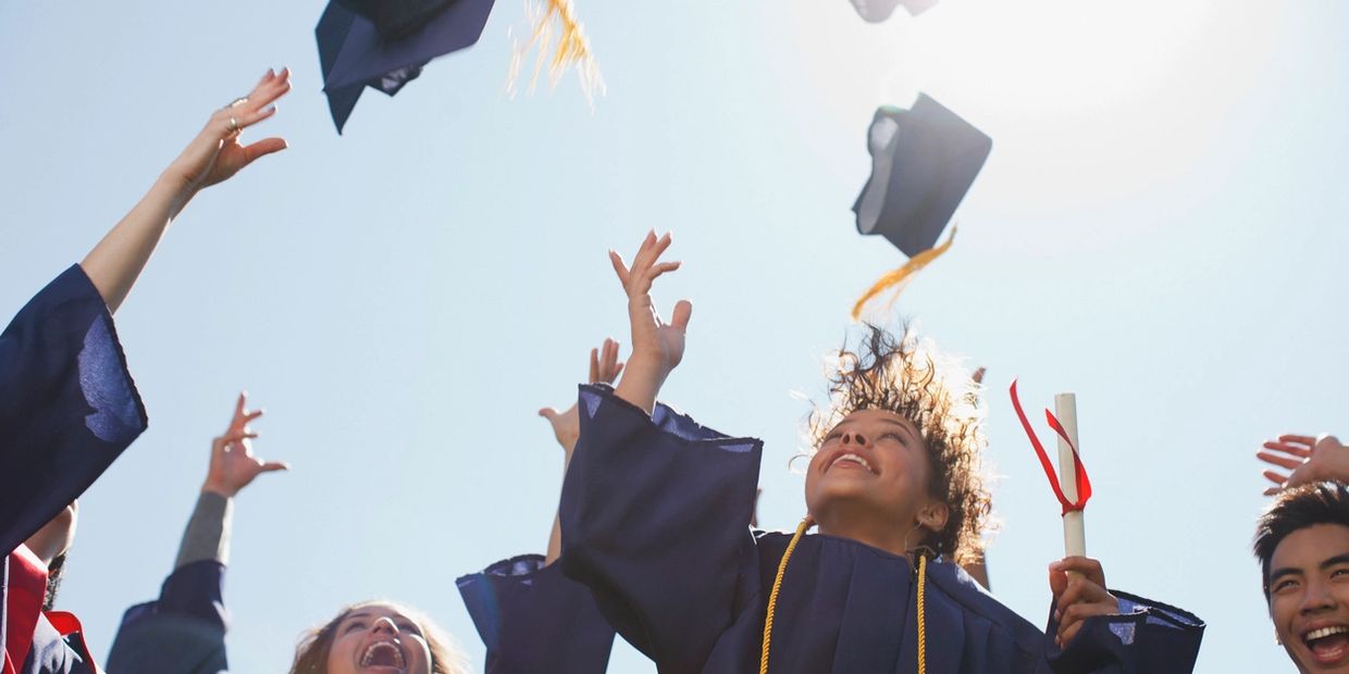 Graduates tossing their caps