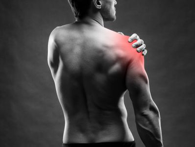 Man holding his painful shoulder.