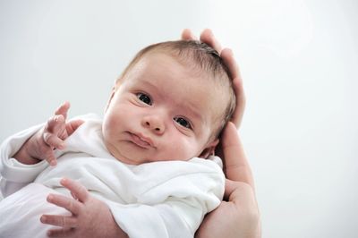 A baby in hands of parent