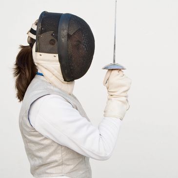 side view of a person wearing fencing dress 