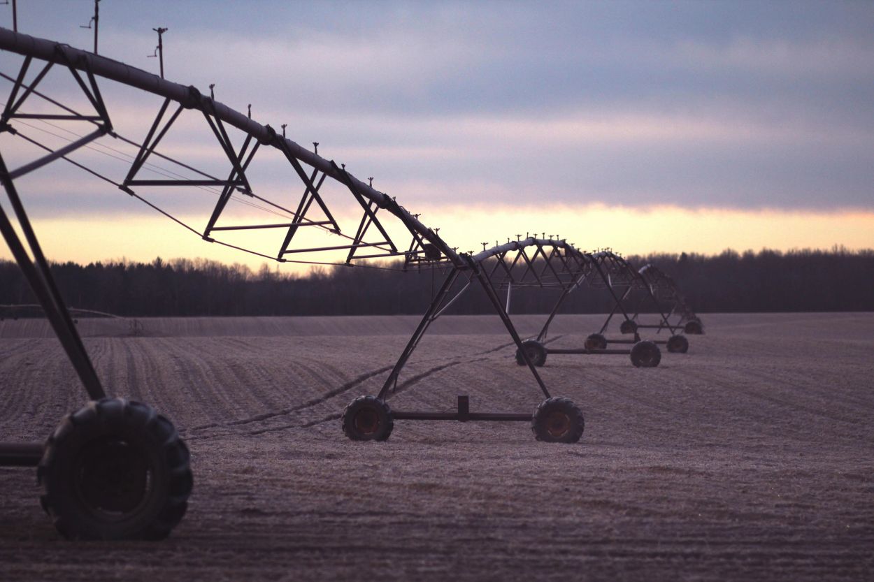 Irrigation system on a farmland at dusk.