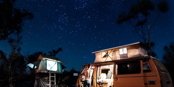 A picture of a camping van in the night 