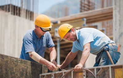 image of men in hard hats working on a construction site