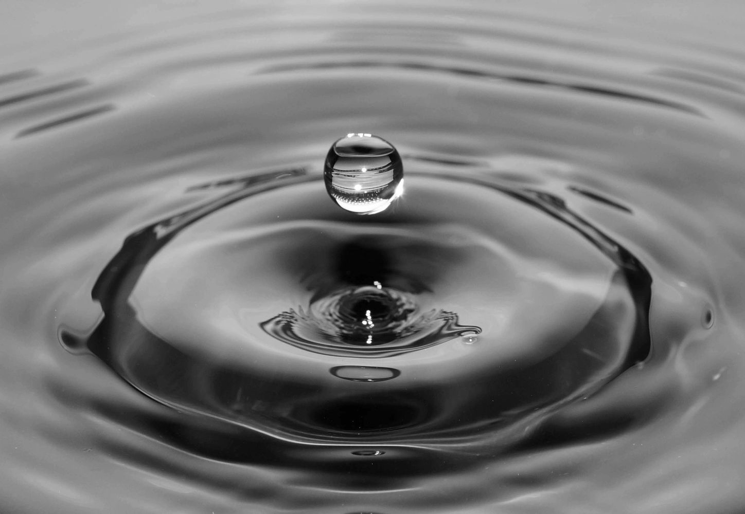 A water drop landing in a pool, and creating ripples