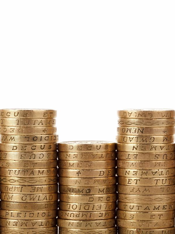 Stacks of British pound coins arranged in three columns.