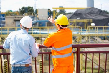 Two people wearing safety equipment