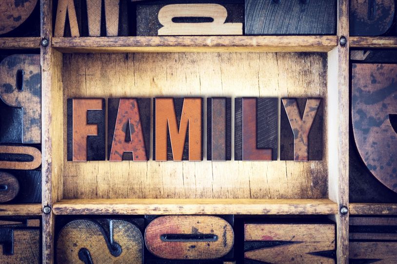 Wooden blocks spelling out the word FAMILY in a vintage type drawer.