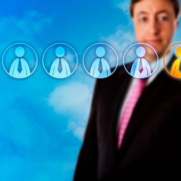 Businessman selecting a candidate from virtual icons against a blue sky.