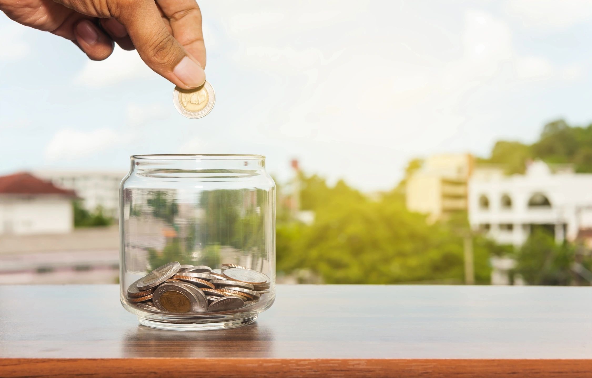 Coins (change) dropped into a jar