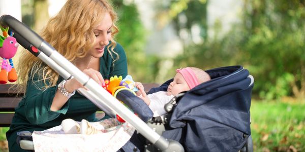 This is a multilingual nanny taking a newborn baby for a walk and talking with the baby. 