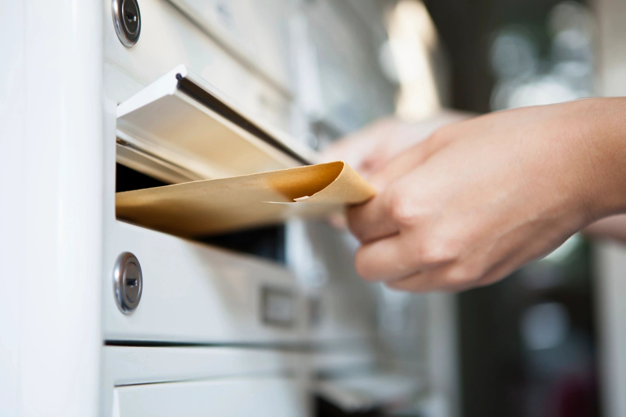 Image of a file being dropped into a mailbox. This references the custom work we do for free. 