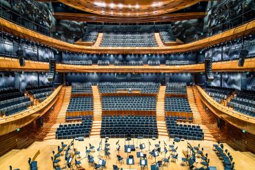 Empty concert hall with orchestra setup.