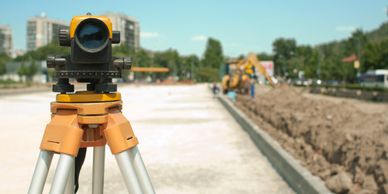 Theodolite outdoors on new road and a bright day. 