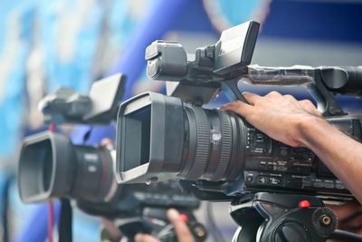Professional video cameras being operated during filming.