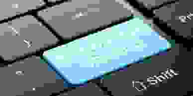 Part of a computer keyboard, with the enter button in blue with the words "Knowledge sharing".