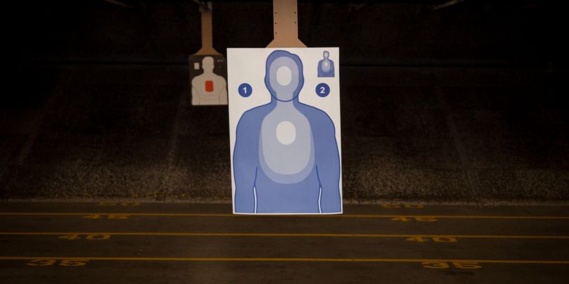 Shooting range target with numbered zones in a dimly lit environment.
