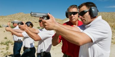 Firearms instructor teaching students at the range