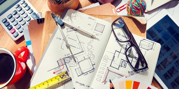 calculator, glasses, coffee cup, notes, pen, and cactus.