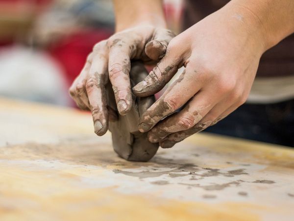 hands kneading pottery