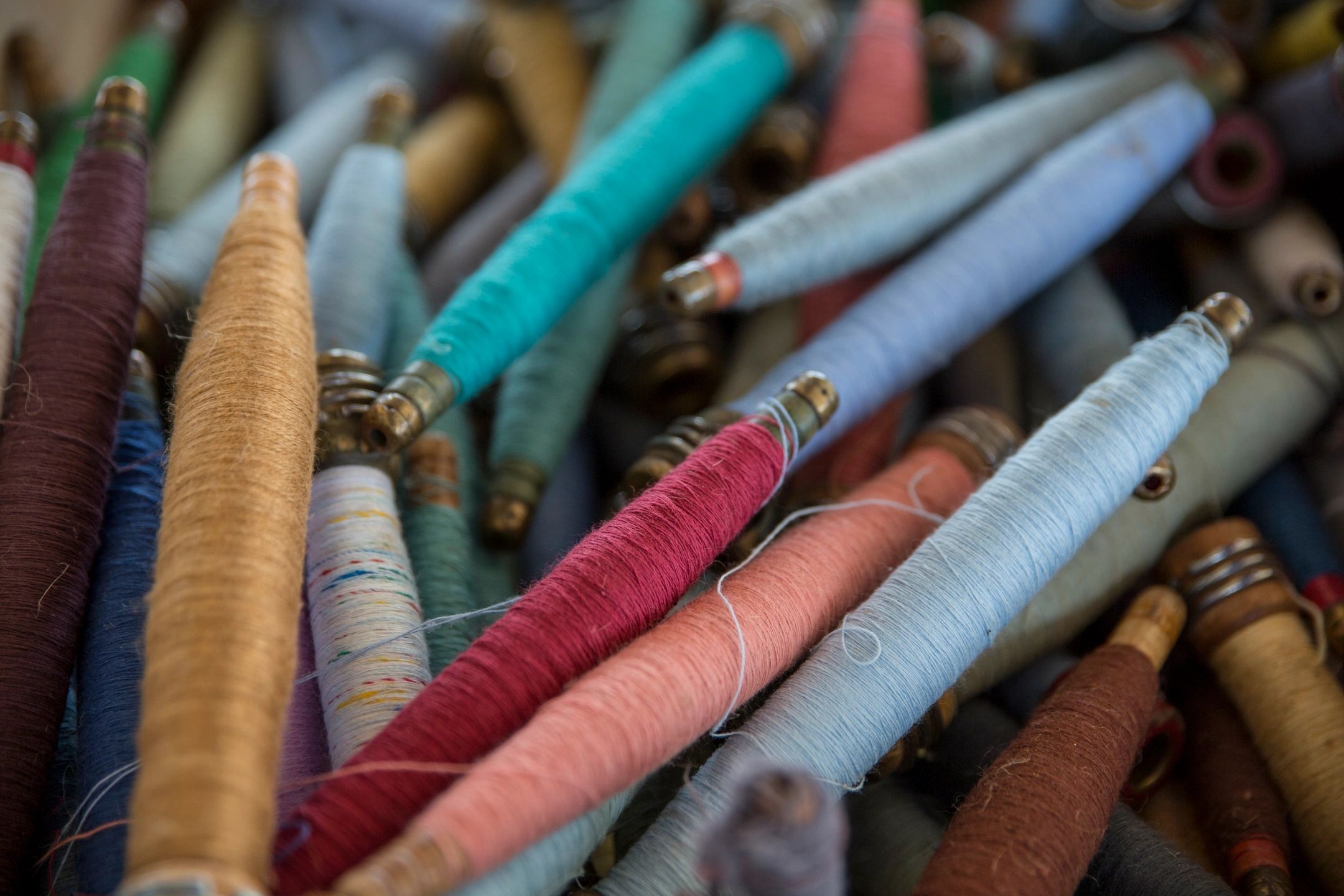 Colorful yarn spools neatly arranged in a close-up view.