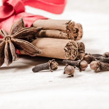 Fragrant cinnamon sticks and star anise arranged on a pristine white background.