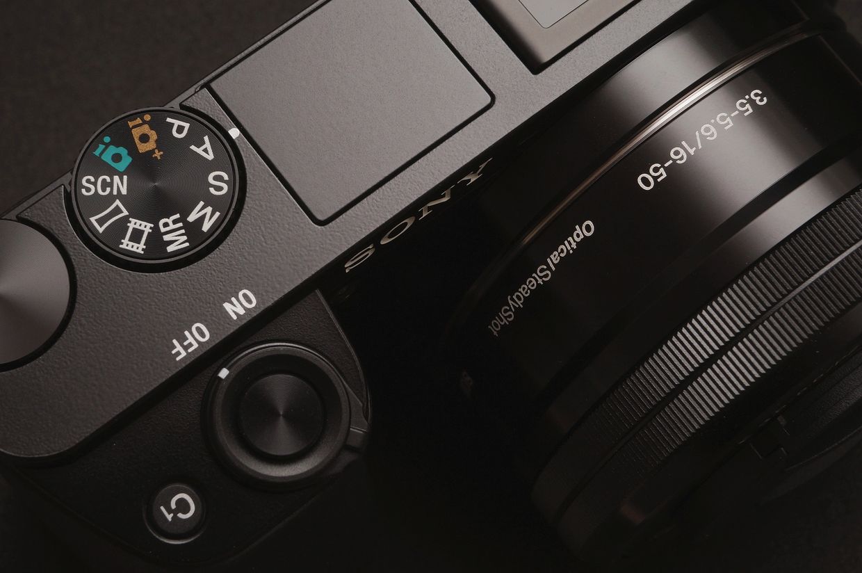 Close-up of a Sony camera mode dial and lens with detailed settings.