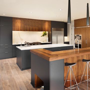 Modern kitchen with wood and black cabinetry and a large island.