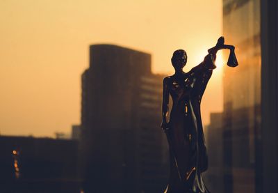 Statue of lady justice with scales, skyline in the background image for Lauren S. Petkin family law 