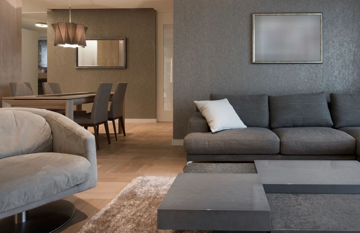 Recently cleaned couch and chair with bright fabric and removed stains, looking fresh and refreshed