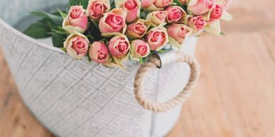 White bucket with pink roses. 