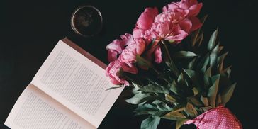 A bouquet of flowers near an open book.