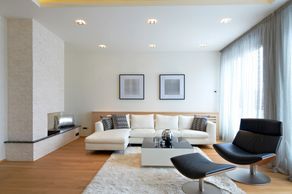 Modern living room with white sofa and sleek chair.