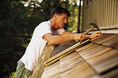 Siding contractor installing siding and roofing