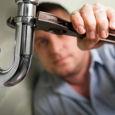 Chicago Plumbing - Andersen Plumbing worker fixing a clogged drain.