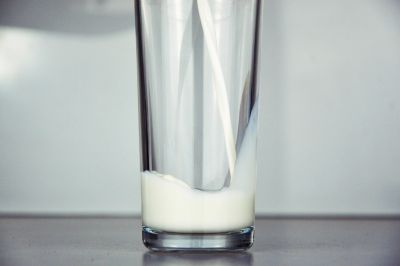 Glass with a small amount of milk.